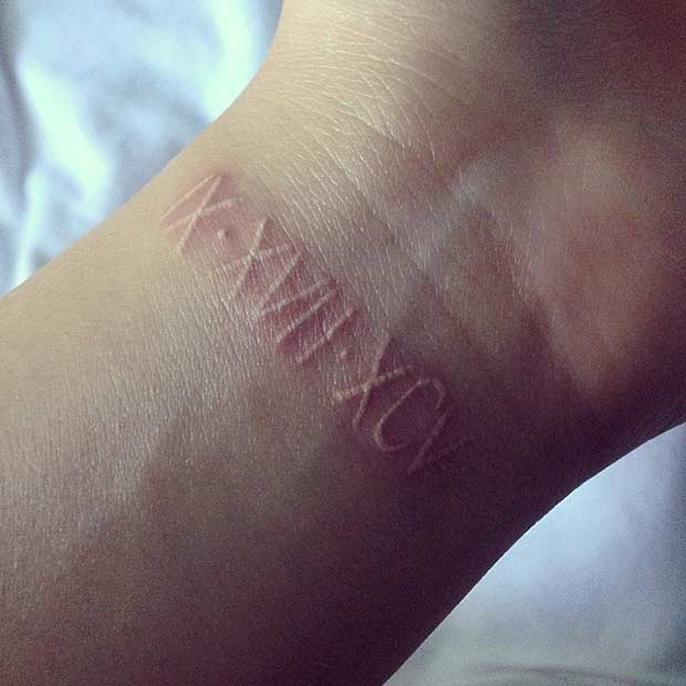 White Ink Roman Numeral Wrist Tattoo
