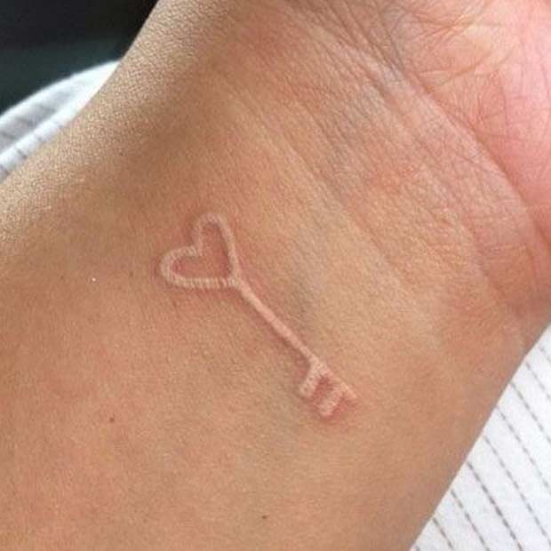 White Ink Key Wrist Tattoo