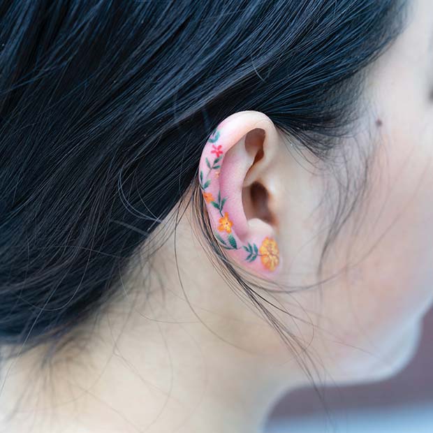 Delicate flower behind the ear tattoo  Tattoogridnet