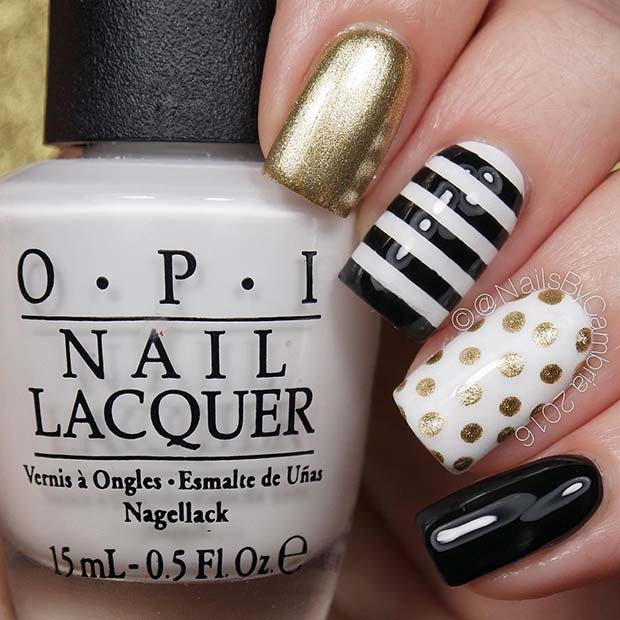 black and white nails with gold rhinestones