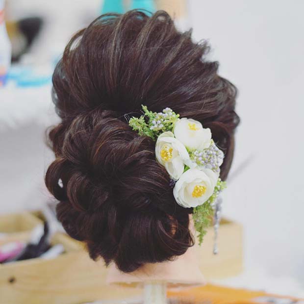 Elegant Low Bun with Floral Accessory