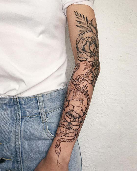 Skull with Snake and Flowers Tattoo isolated on white