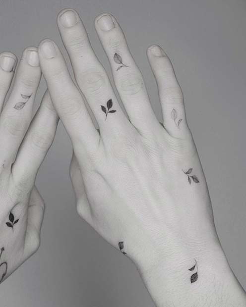 Fine line freehand leaves tattoo on the wrist