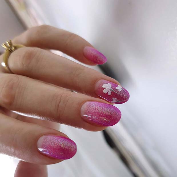 Pretty Pink Glitter Nails with a White Flower